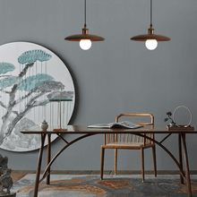 Load image into Gallery viewer, Two Oriental Wood Disc Lights above oriental dining table
