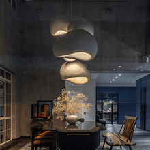 Load image into Gallery viewer, Japanese Style Pebble Pendant Lights above black dining room table
