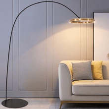 Load image into Gallery viewer, Gold Creative Designer Ring Floor Lamp next to living room sofa

