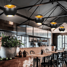 Load image into Gallery viewer, Black Modern Globe Pendant Lights hanging from ceiling above restaurant tables
