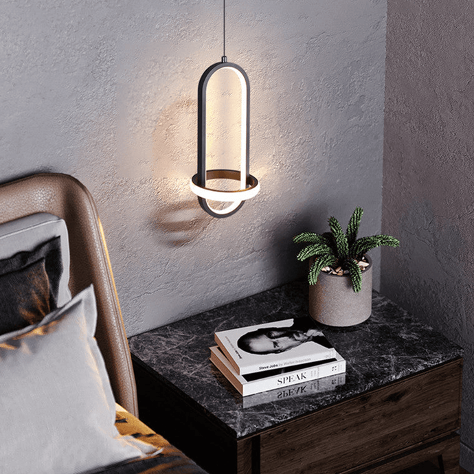 Black Scandinavian LED Pendant Light above bedside table in bedroom