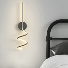Load image into Gallery viewer, Black Nordic Spiral Wall Light on bedroom wall next to bed
