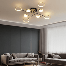 Load image into Gallery viewer, Gold Modern Neutral Chandelier in living room above sofas
