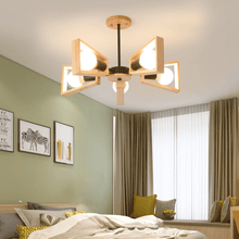 Load image into Gallery viewer, Black Modern Wood Framed Chandelier above bed with paintings on wall
