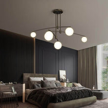 Load image into Gallery viewer, Black Modern Long Arm Chandelier above bed in bedroom

