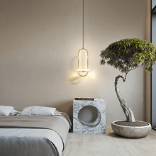 Load image into Gallery viewer, Gold Scandinavian LED Pendant Light above marble bedside table in bedroom
