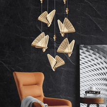 Load image into Gallery viewer, Butterfly Pendant Light above living room chair
