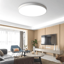 Load image into Gallery viewer, White Ultra-Thin LED Ceiling Light on living room ceiling above sofa and coffee table
