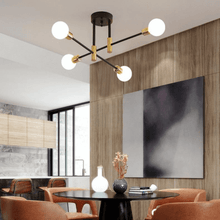 Load image into Gallery viewer, Black &amp; Gold LED Chandelier above living room table
