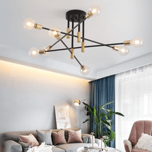 Load image into Gallery viewer, Black &amp; Gold LED Chandelier above table in living room
