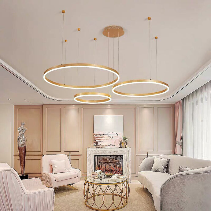 Gold Circle LED Chandelier above sofa in living room