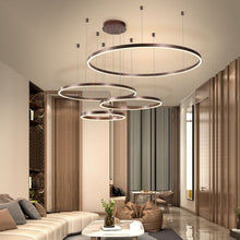 Load image into Gallery viewer, Brown Circle LED Chandelier above coffee table in living room
