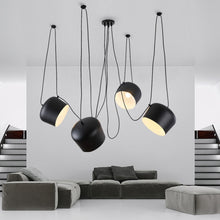 Load image into Gallery viewer, Four Modern Studio Pendant Lights hanging from ceiling in living room with corner sofa behind
